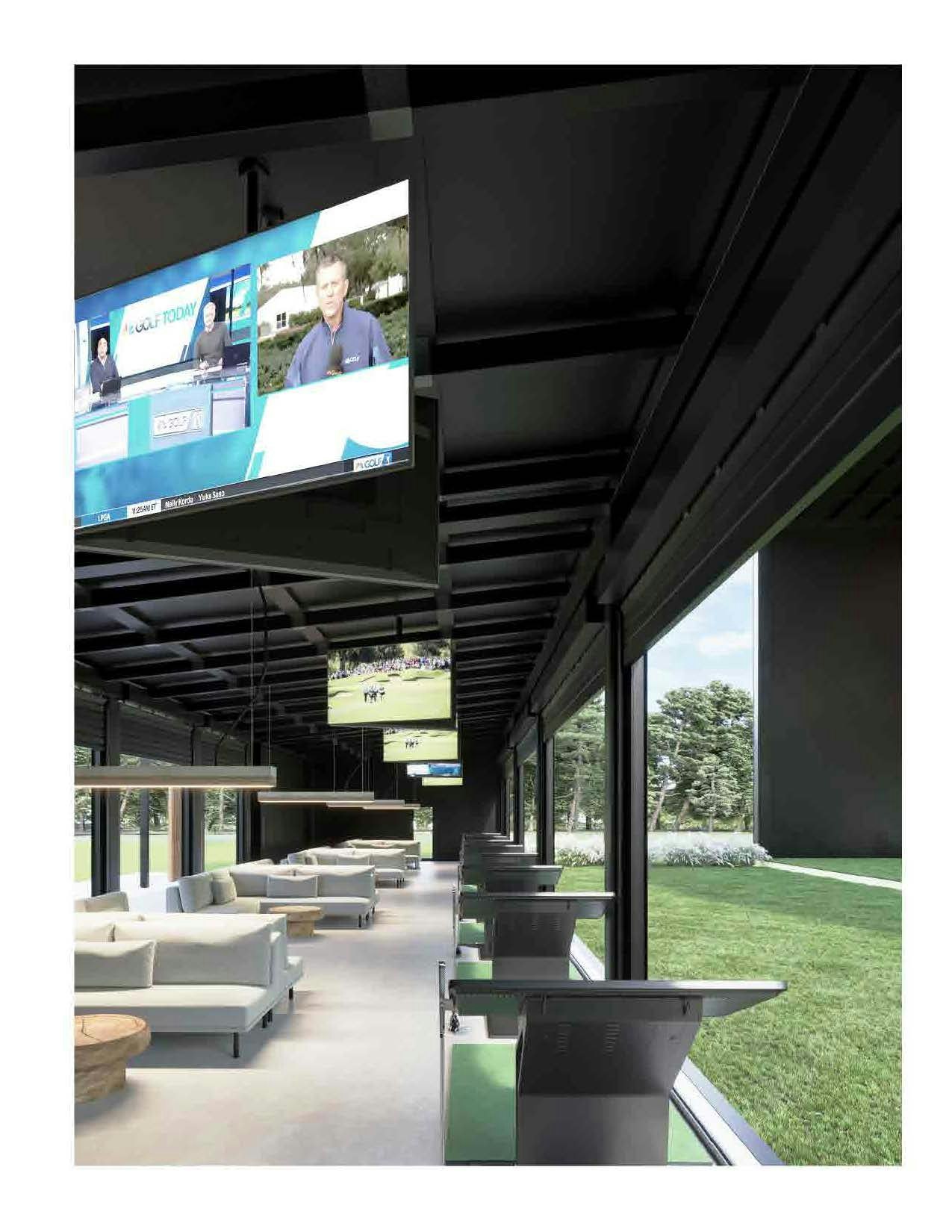 Modern lounge with sofas, tables, and mounted TV screens, overlooking a green outdoor area.