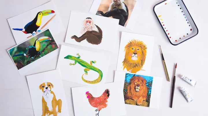 An assortment of animal illustrations, including a toucan, monkey, lion, dog, and chicken, alongside art supplies.