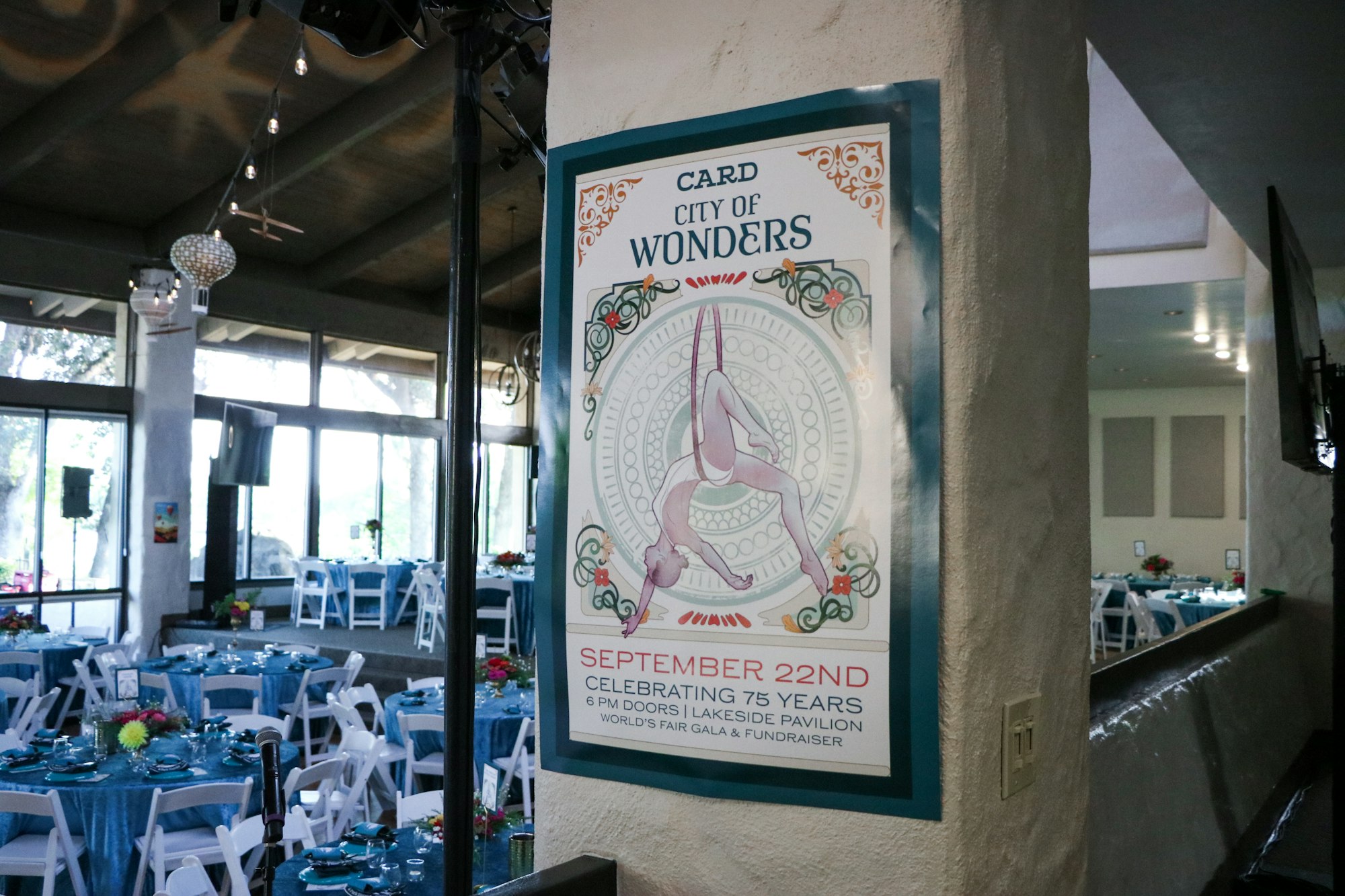 Poster for "City of Wonders" gala on September 22nd; decorated event space with round tables and chairs in the background.