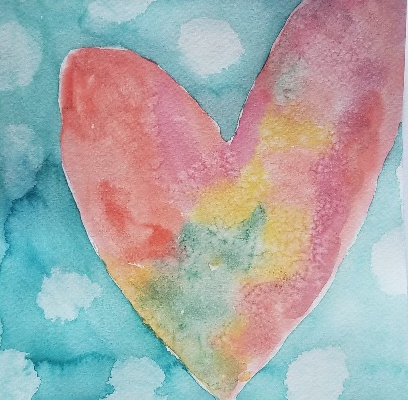 A colorful watercolor heart against a blue background with soft, round shapes.