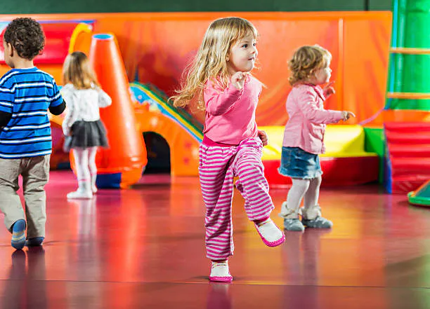 Children playing in a colorful indoor playground.