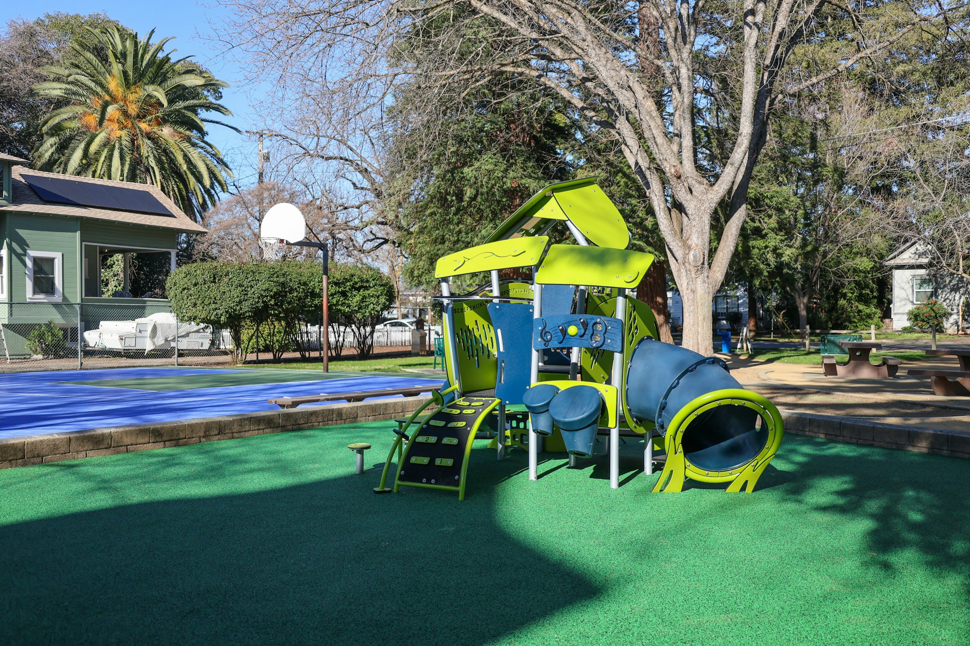 May contain: outdoor play area, outdoors, play area, grass, plant, desk, furniture, and table