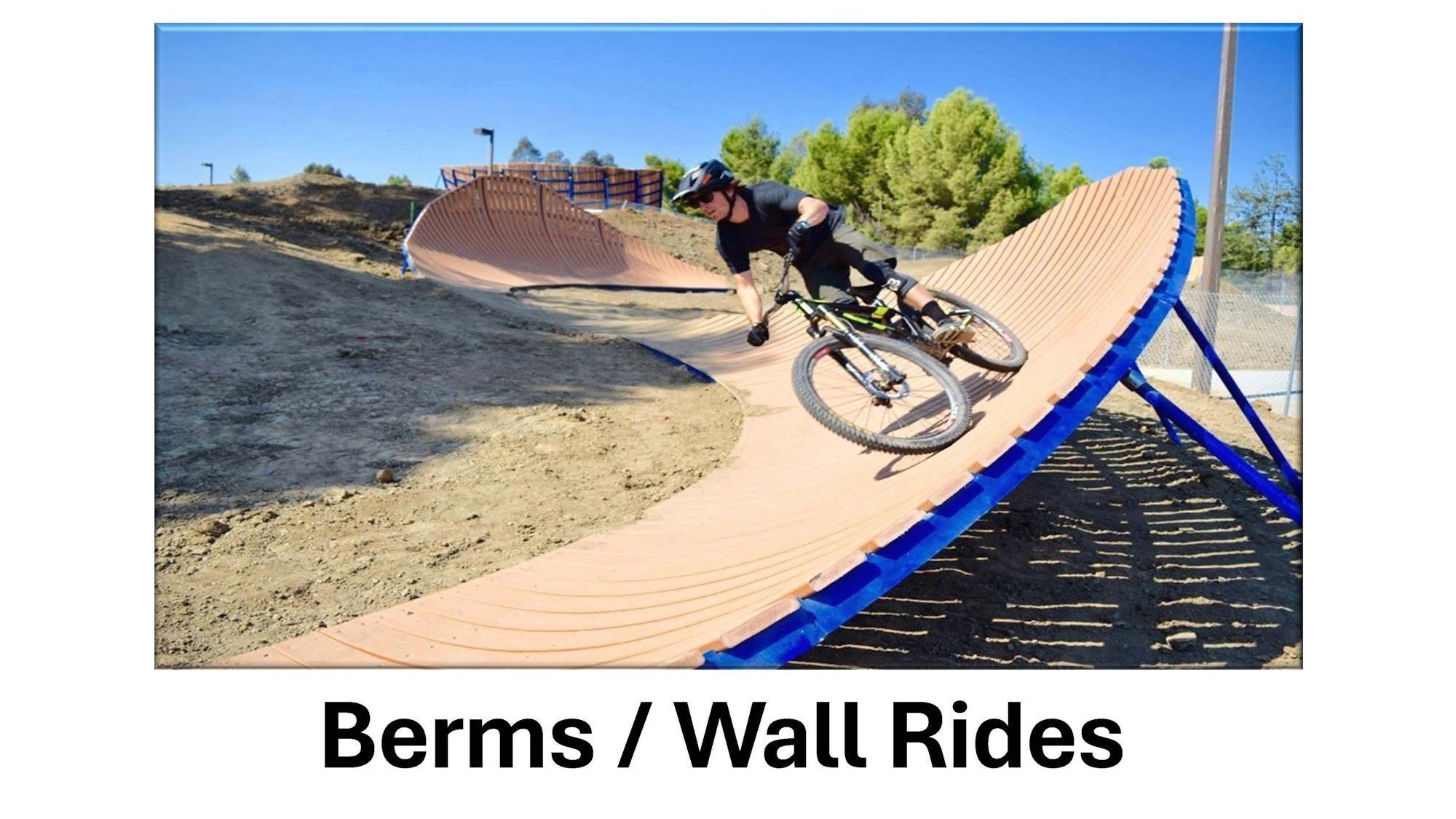 A cyclist rides on a berm/wall ride track.