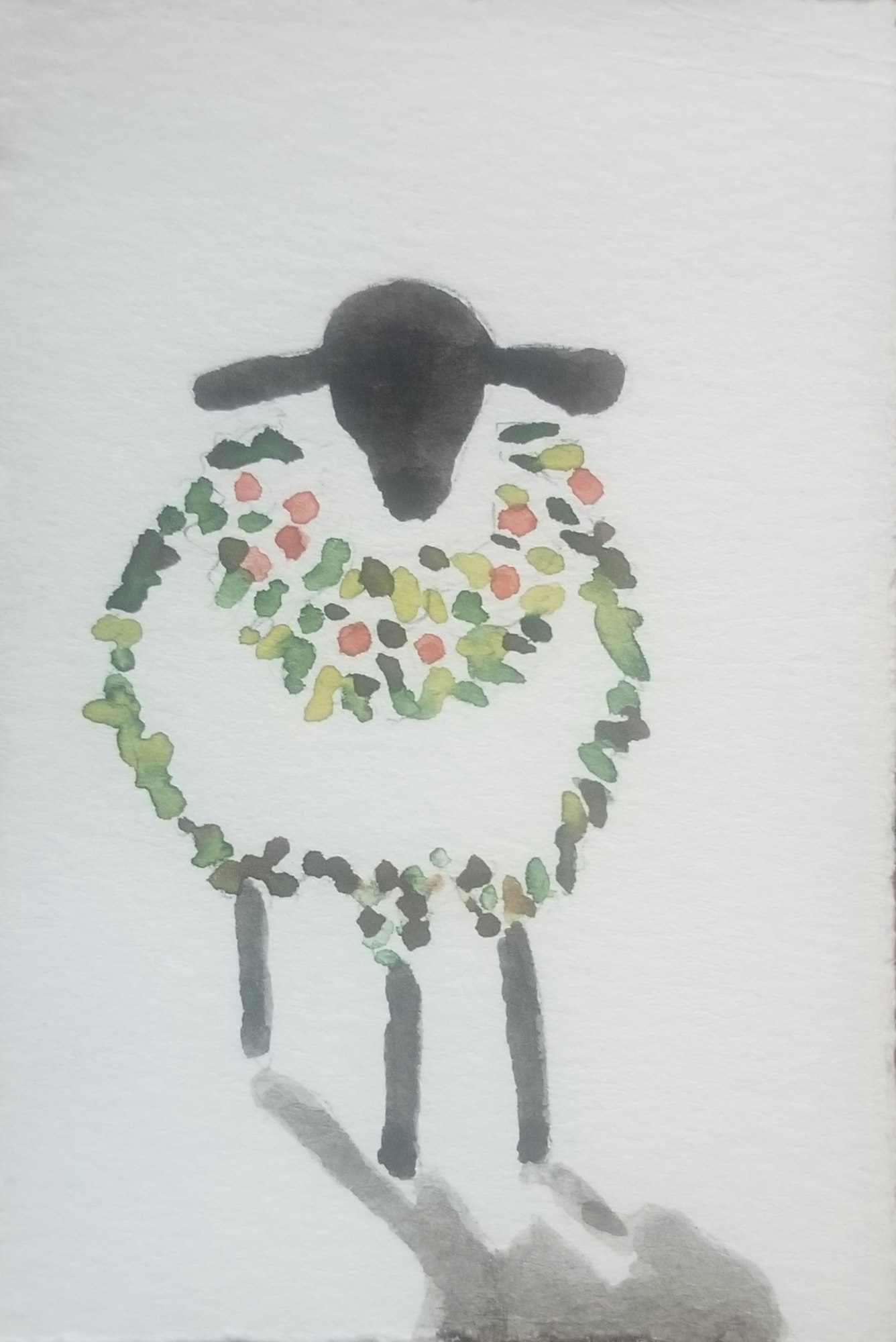 A sheep painted with a black head and colorful dots in its wool, against a white background.