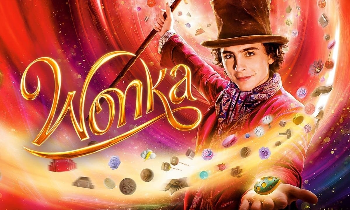 A colorful "Wonka" poster with a person in a hat, surrounded by candies and swirls of vibrant colors.