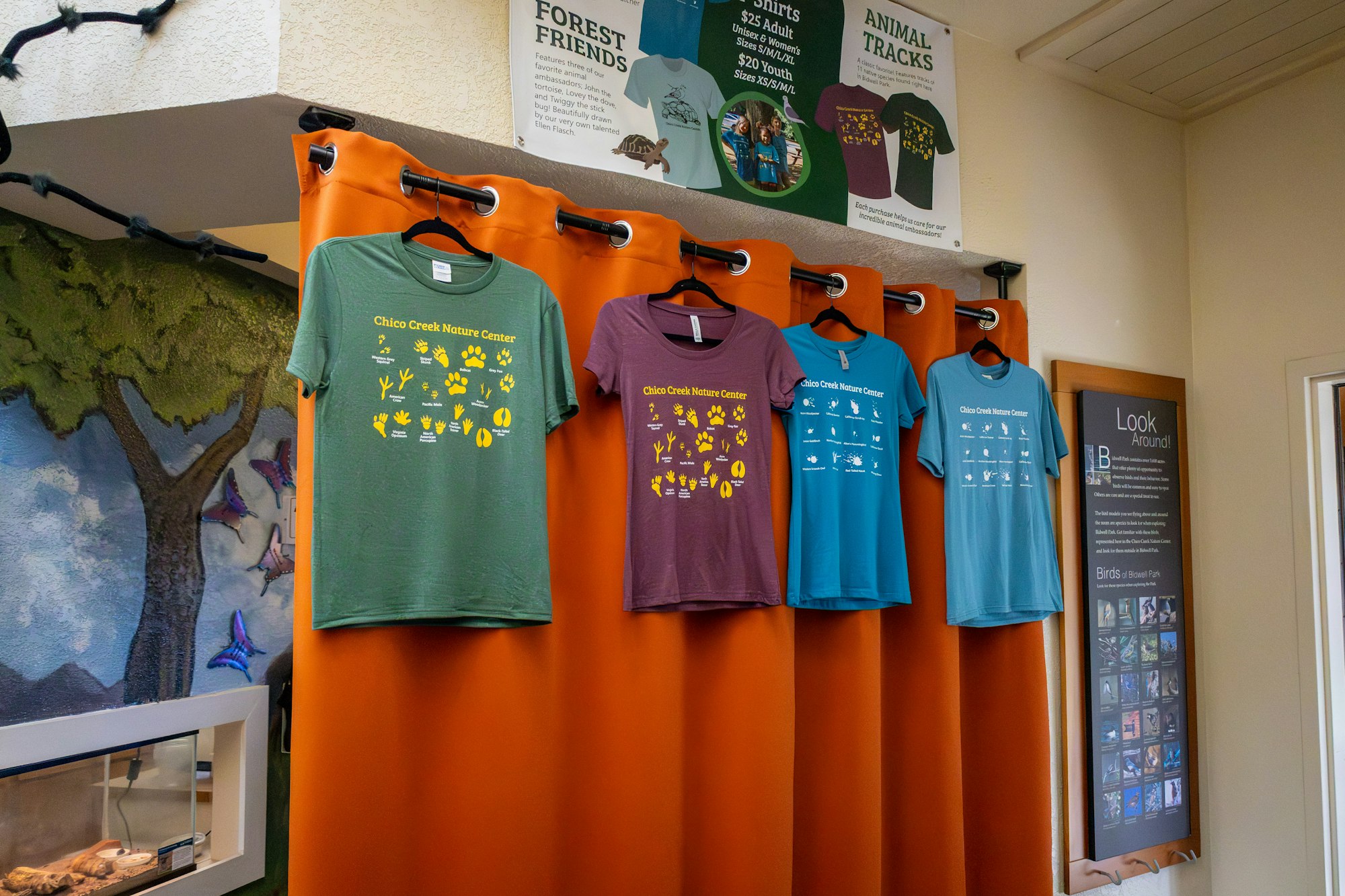 The image features shirts from the Chico Creek Nature Center, each displaying different nature-themed graphics.