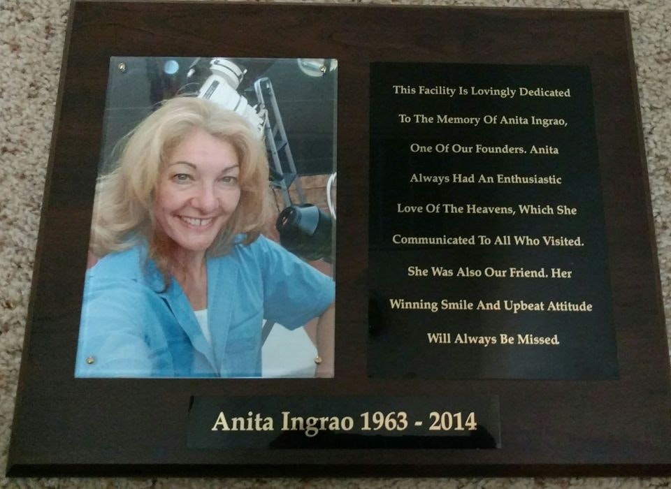 A memorial plaque for Anita Ingrao (1963-2014) featuring her photo and a dedication honoring her enthusiastic love of the heavens.