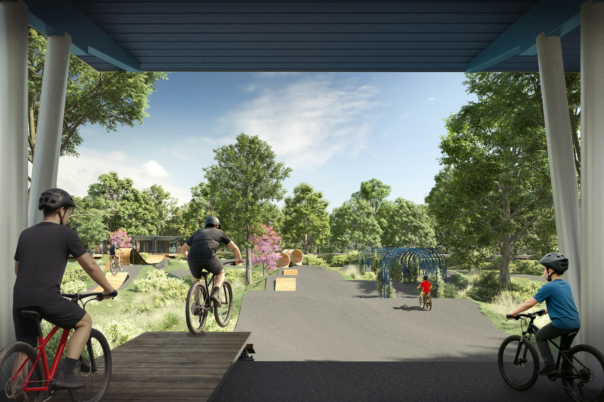 Cyclists in a park with biking paths, ramps, and greenery, under clear skies.