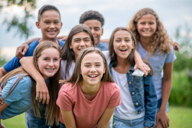 A group of happy kids posing outdoors.