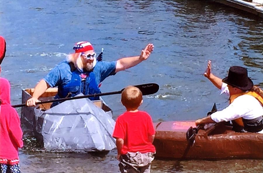 May contain: clothing, lifejacket, vest, boy, child, male, person, oars, boat, canoe, canoeing, leisure activities, rowboat, sport, transportation, vehicle, water, water sports, watercraft, face, head, photography, portrait, and outdoors