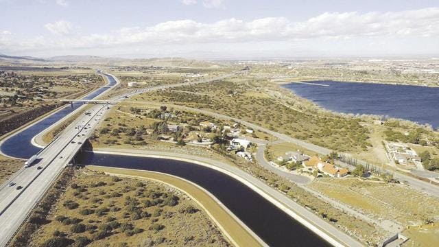 May contain: road, bridge, building, nature, outdoors, landscape, scenery, water, highway, and freeway