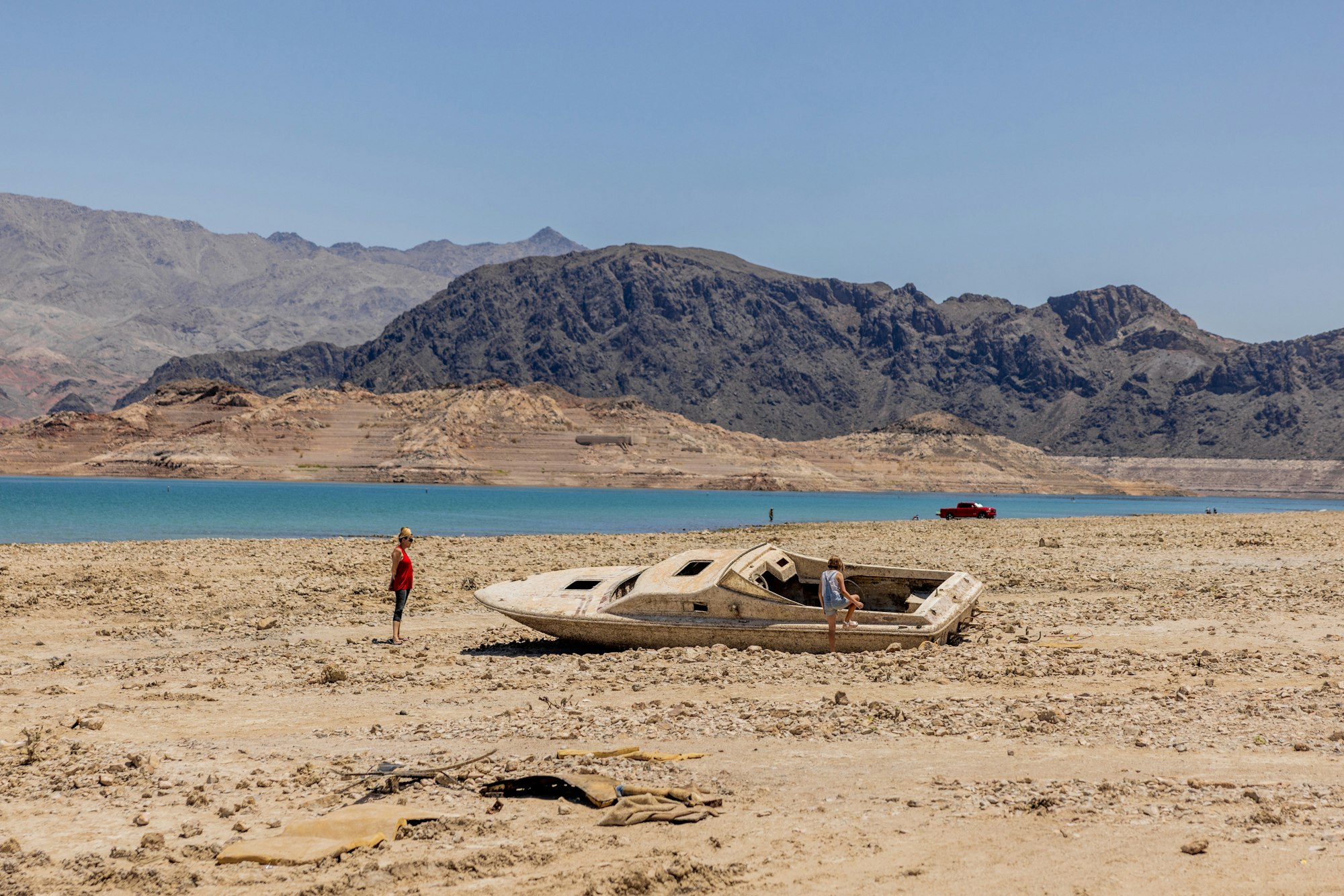 May contain: watercraft, vehicle, transportation, boat, person, pickup truck, truck, outdoors, hat, clothing, nature, and scenery
