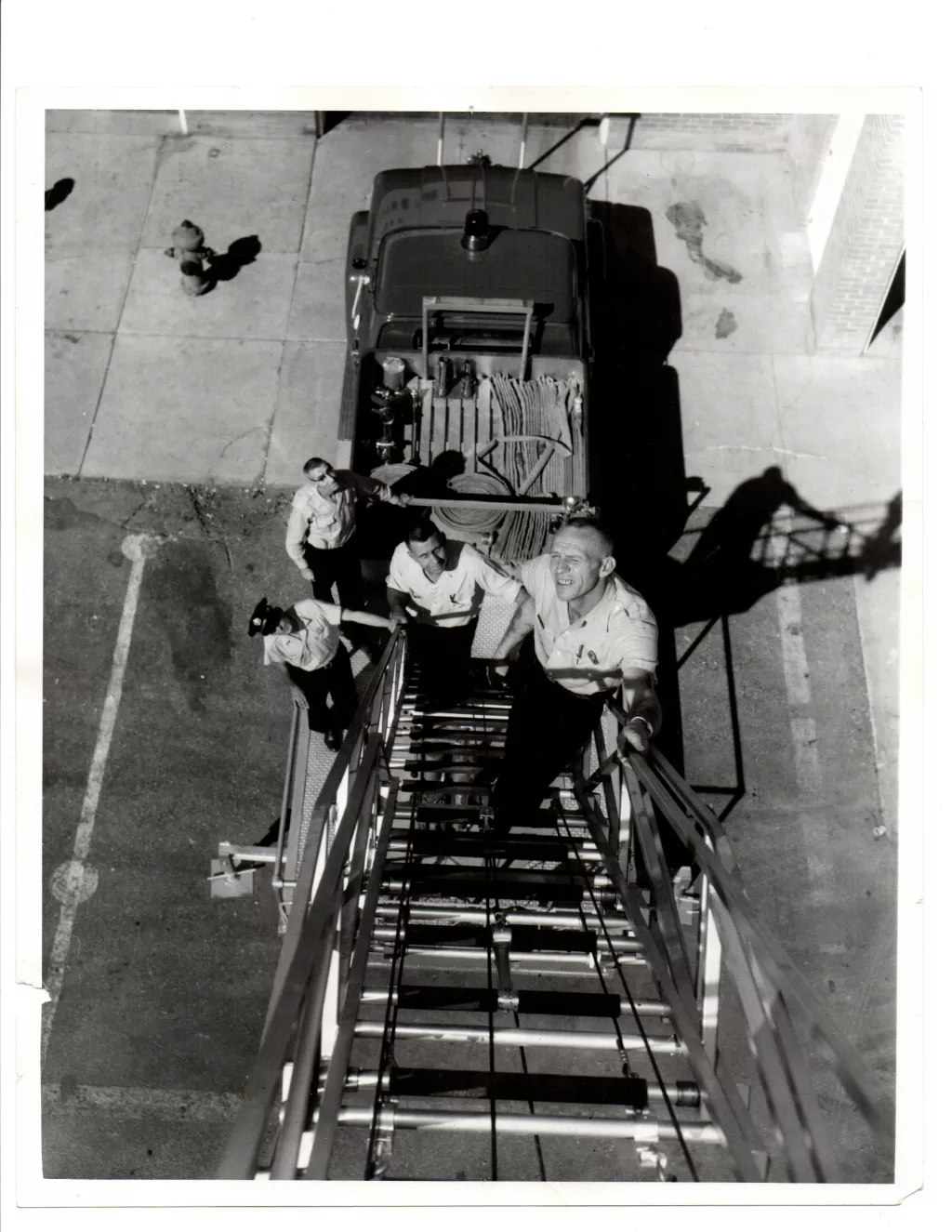 vintage, firefighters on fire engine ladder