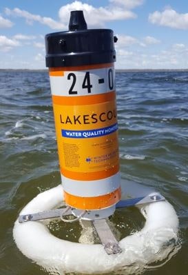 A water quality monitoring device floating on a lake.