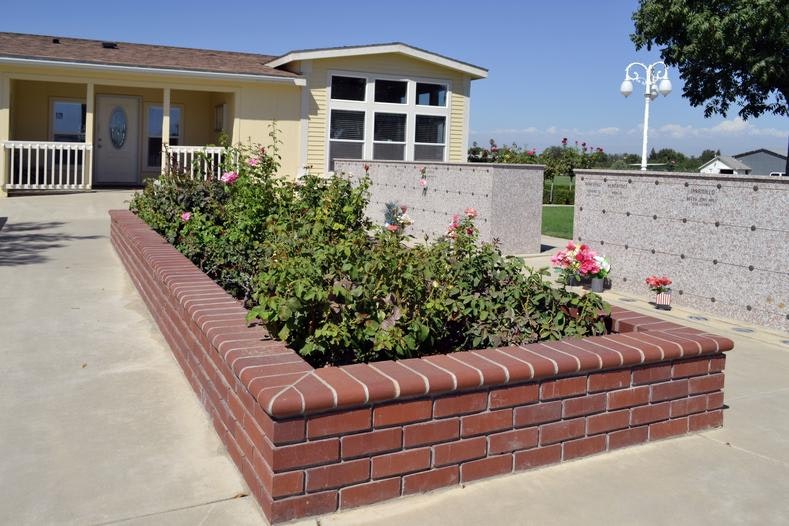 May contain: brick, vase, plant, pottery, potted plant, jar, housing, building, outdoors, yard, nature, urban, neighborhood, vegetation, and bush