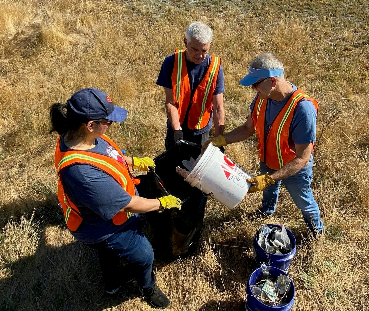 Three clean up volunteers in McNabney Marsh in Martinez, California