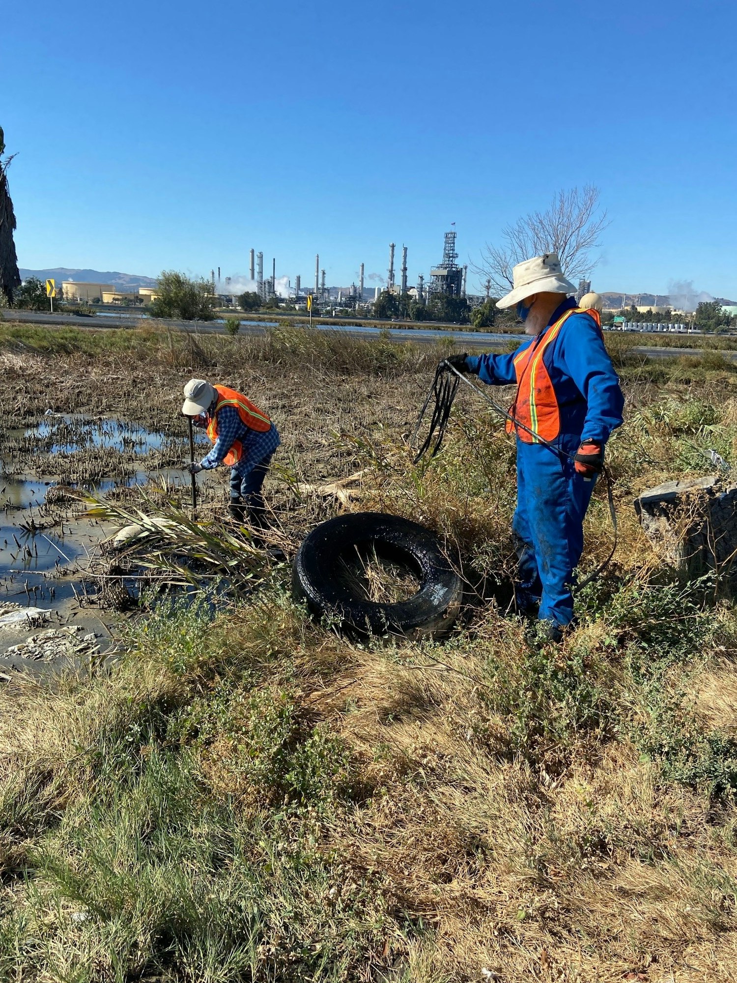 May contain: worker, person, glove, clothing, hat, and soil