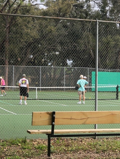 May contain: furniture, bench, person, human, sport, tennis court, sports, and tennis