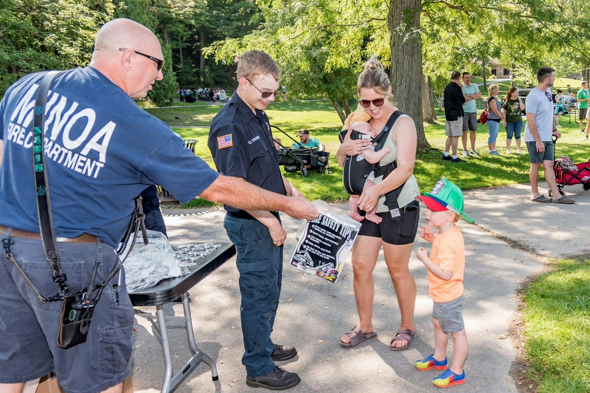 Minoa firefighters speak with a mother and her child