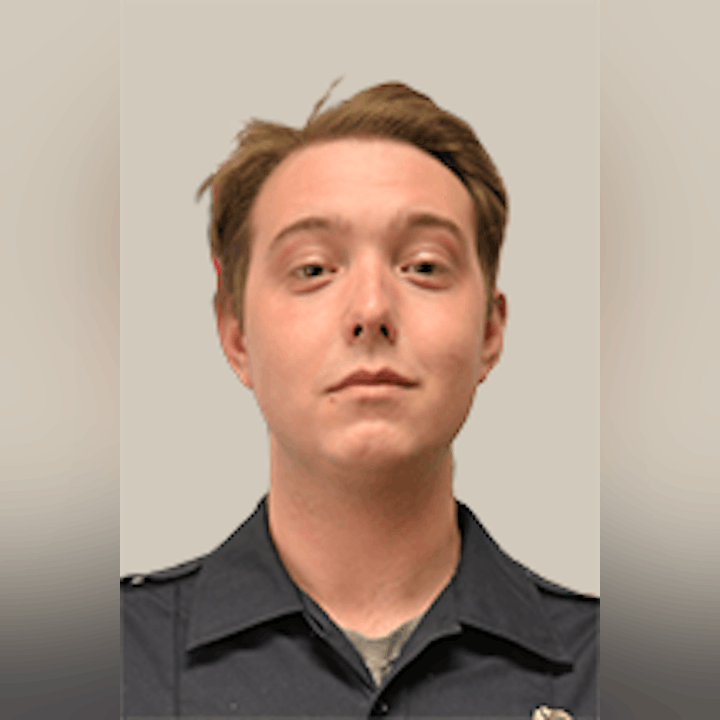 Zach Berg in a firefighter's uniform with a neutral expression, facing forward.