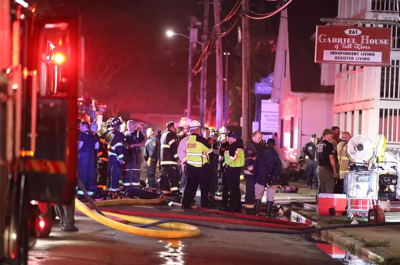 Emergency responders with equipment gathered outside the Gabriel House assisted-living facility..