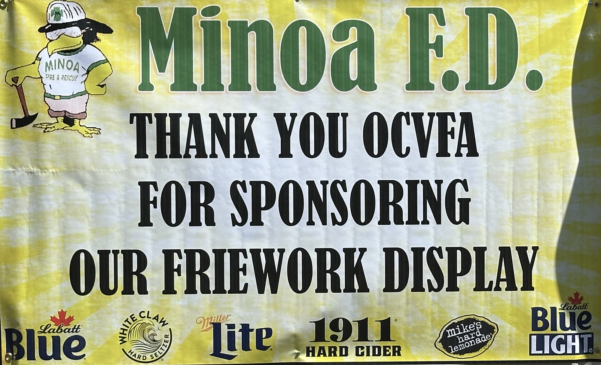 A banner thanking OCVFA for sponsoring a firework display, with logos of drinks and a duck cartoon firefighter.