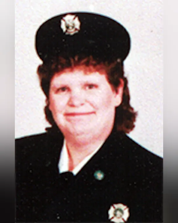 Cindy Steele in a uniform, wearing a cap with an emblem.