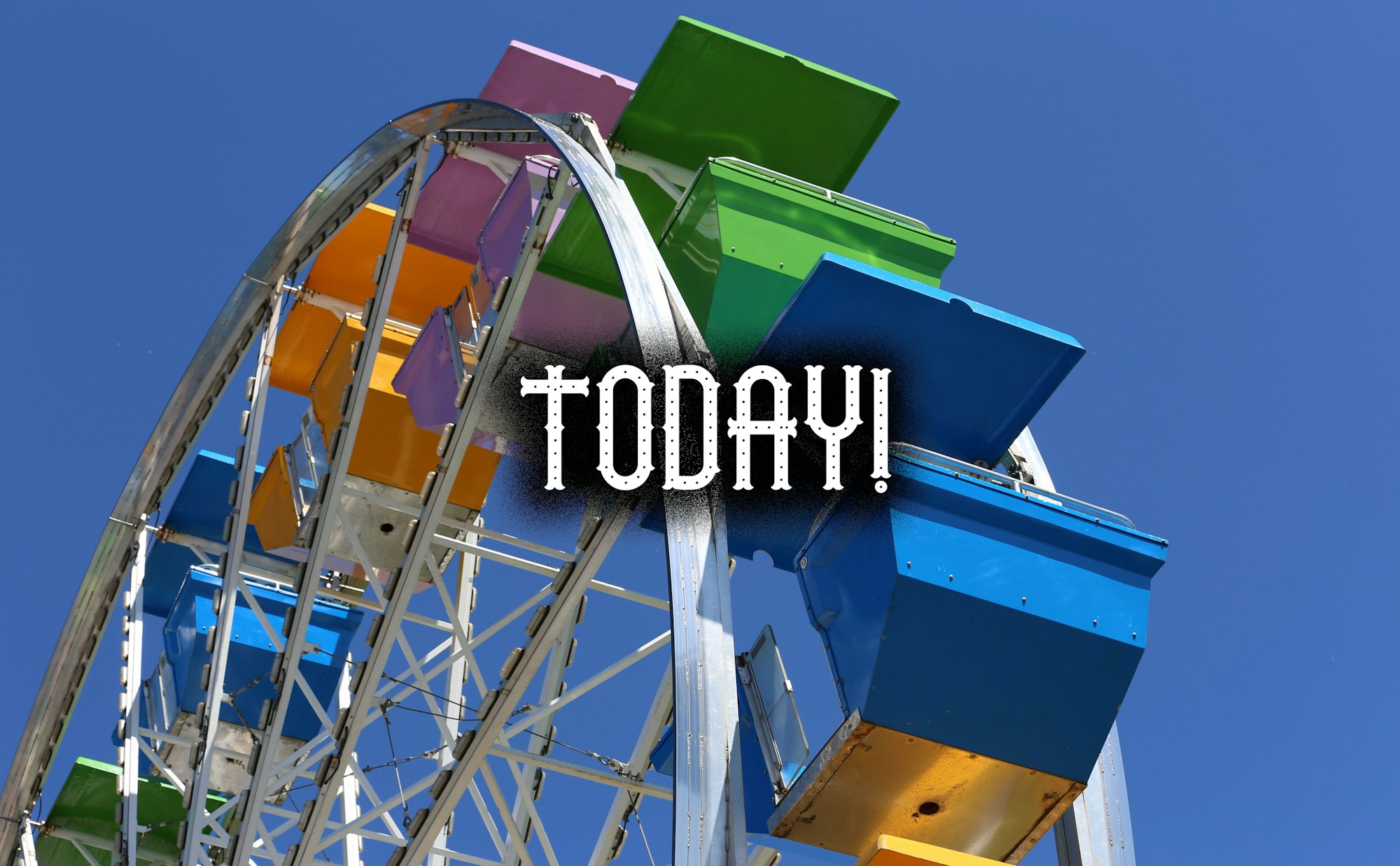 Colorful Ferris wheel with "TODAY!" text, against a clear blue sky.