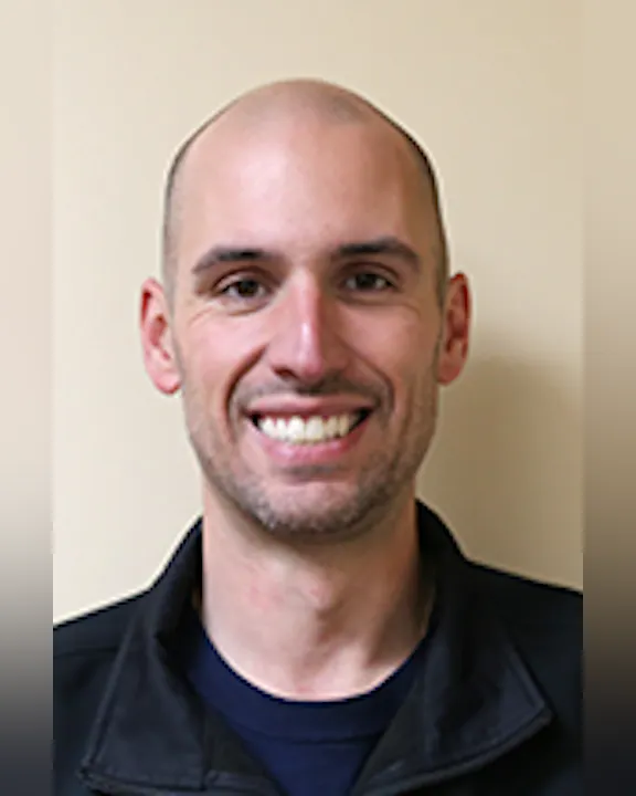 Portrait of Mike DiMauro, against a neutral background.