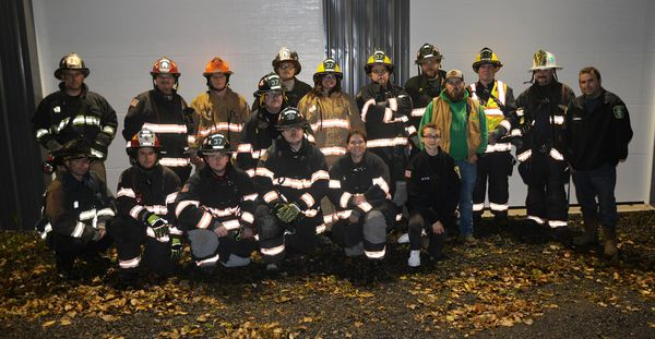 A group of firefighters and emergency personnel posing for a photo.