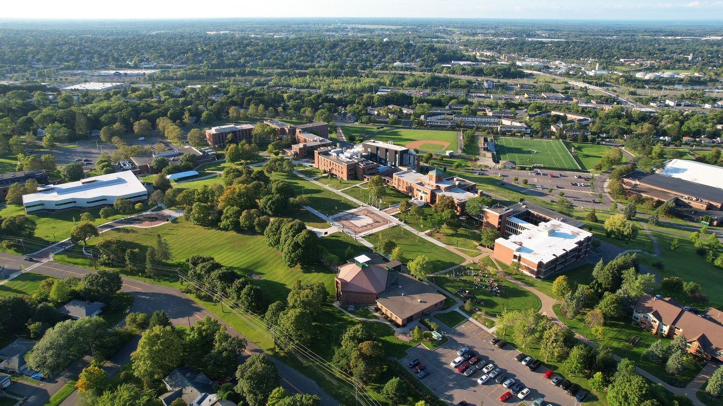 Aerial view of Lemoyne College campus with buildings, sports fields, roads, parking, and surrounding greenery.