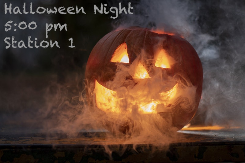 Carved pumpkin with glowing eyes, nose, mouth, surrounded by smoke, with "Halloween Night 5:00 pm Station 1" text overlay.
