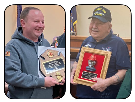 Erich Schepp and wayne Konseck smiling, each holding a plaque with awards.