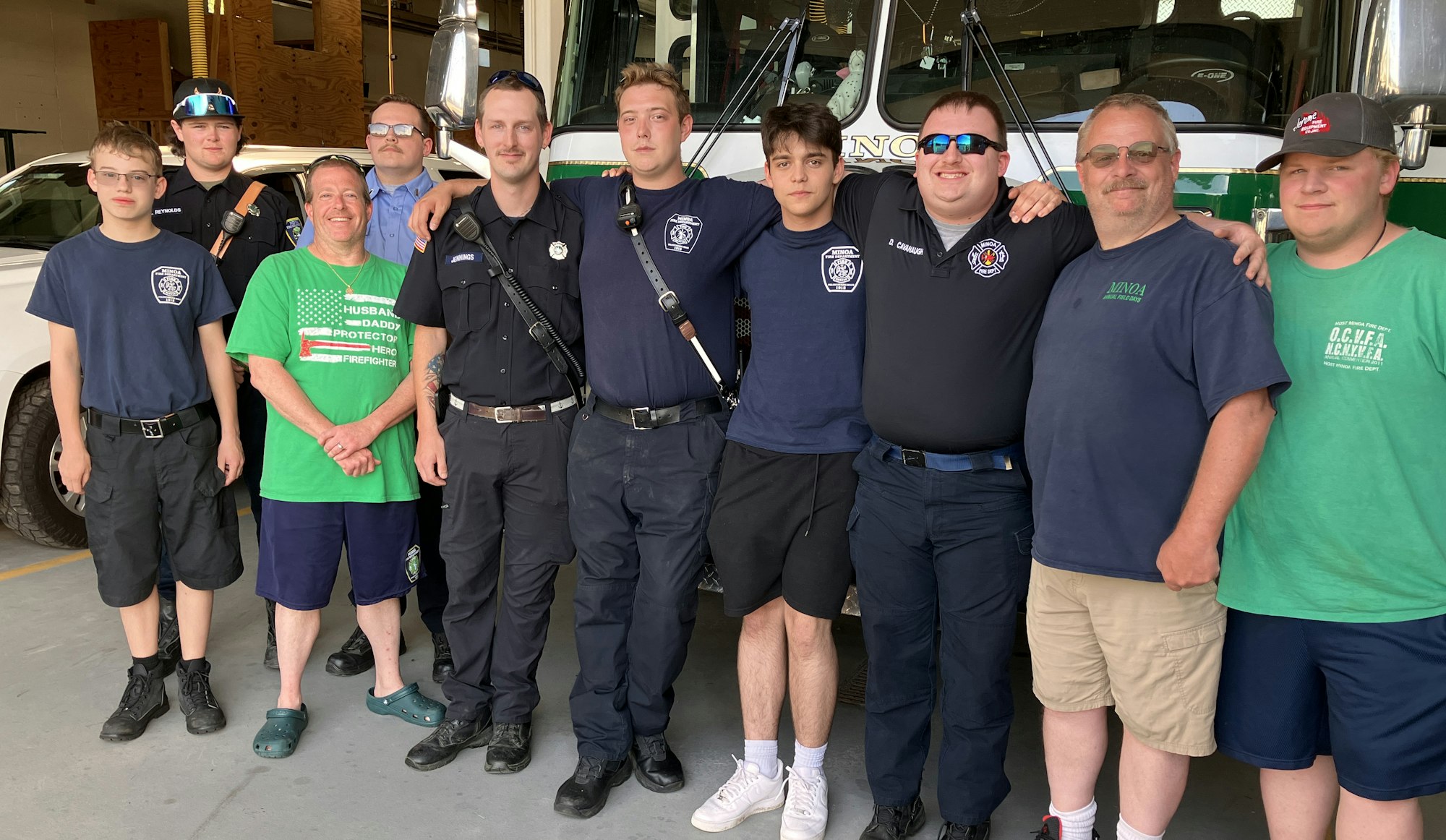 Several volunteer firefighters gather to say "good-bye" to Alec.