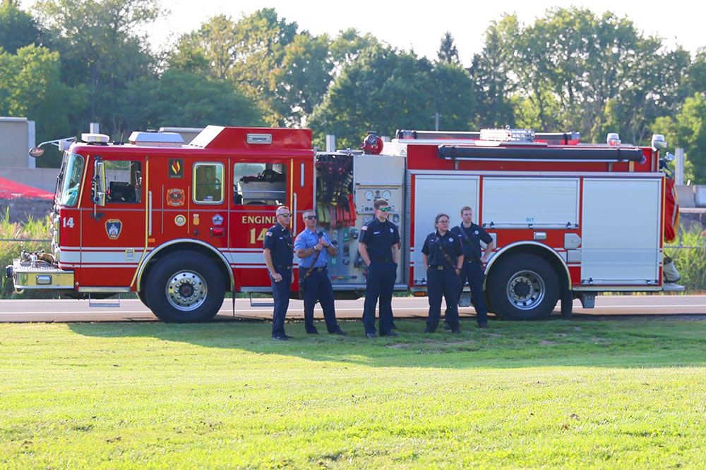 DeWitt Firefighters standing by their fire engine.f