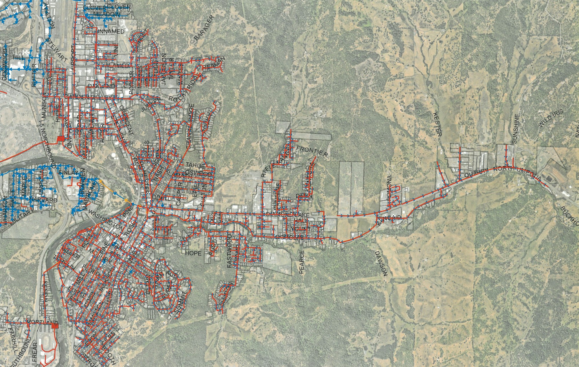 A detailed map showing streets, labels, and infrastructure in a densely constructed area surrounded by rural land.