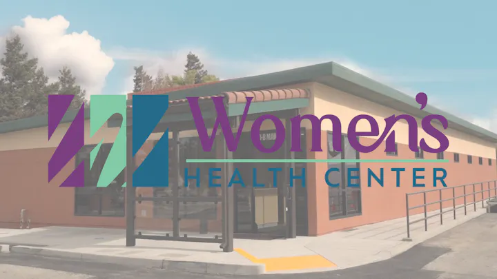 A building labeled "Women's Health Center" with a colorful geometric logo.