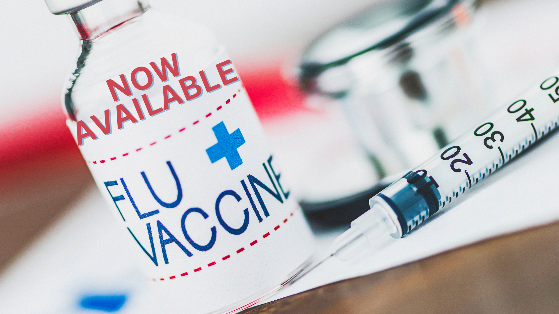 A flu vaccine vial and a syringe.