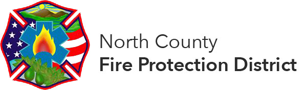 Logo of North County Fire Protection District with a badge design featuring a flame and U.S. flag elements.