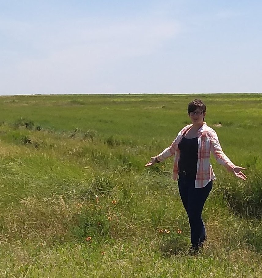 May contain: grassland, field, outdoors, nature, person, human, countryside, clothing, apparel, grass, and plant