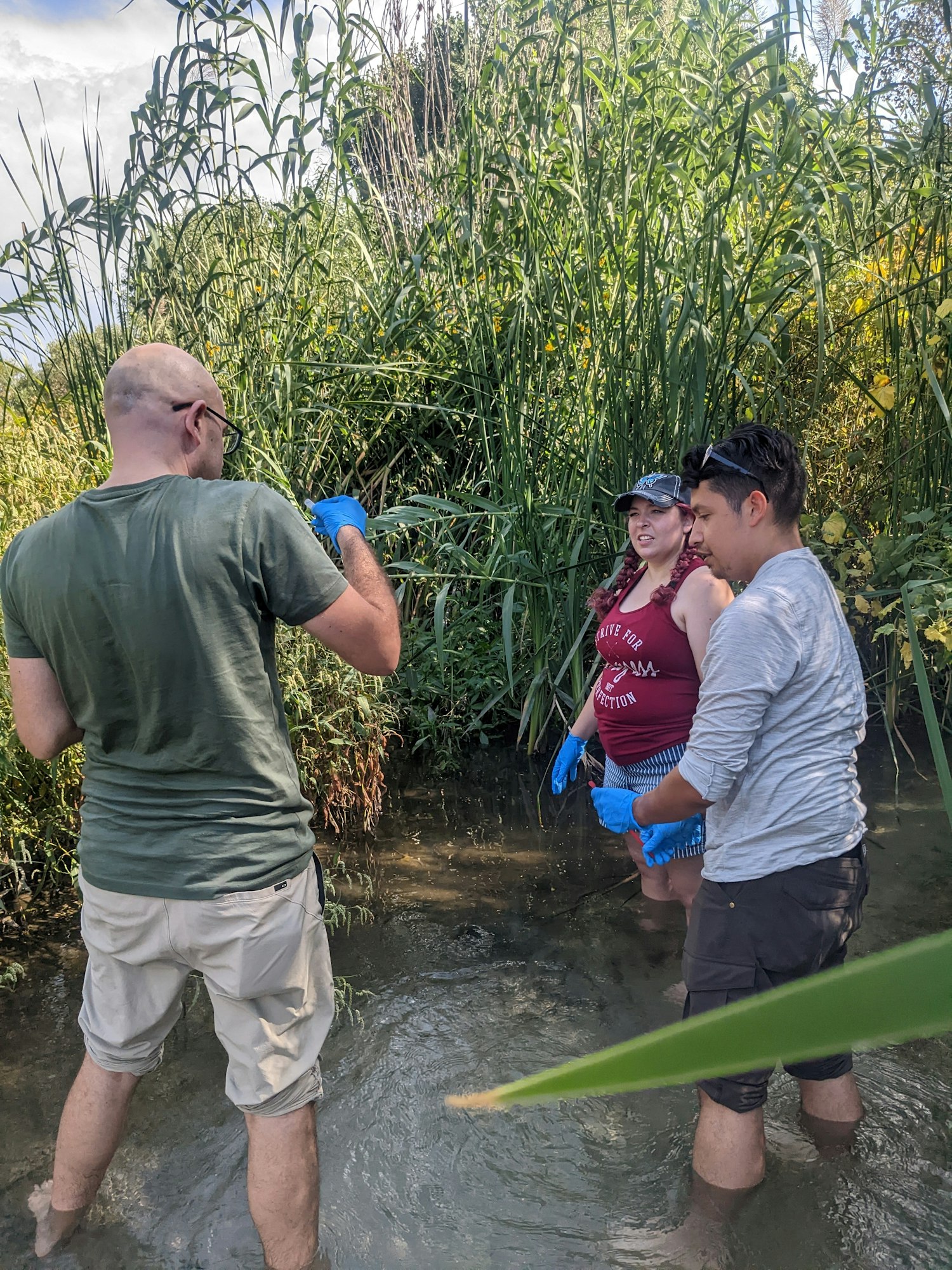 May contain: shorts, clothing, glove, t-shirt, hat, person, man, adult, male, land, outdoors, nature, vegetation, plant, glasses, accessories, summer, soil, and water