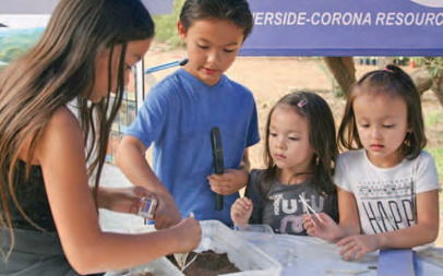 Children sampling soil texture.