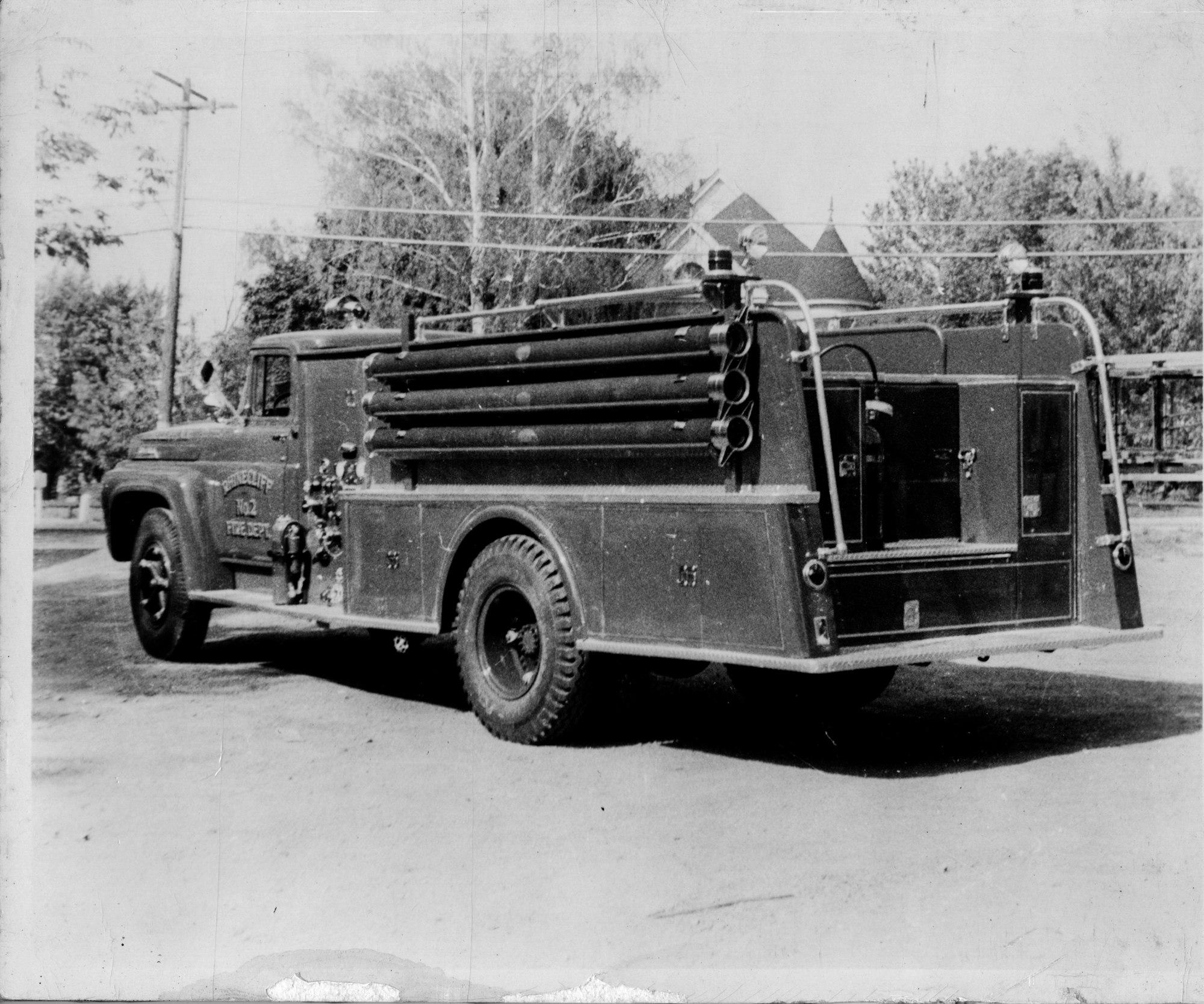 Vintage fire engine parked on a street.