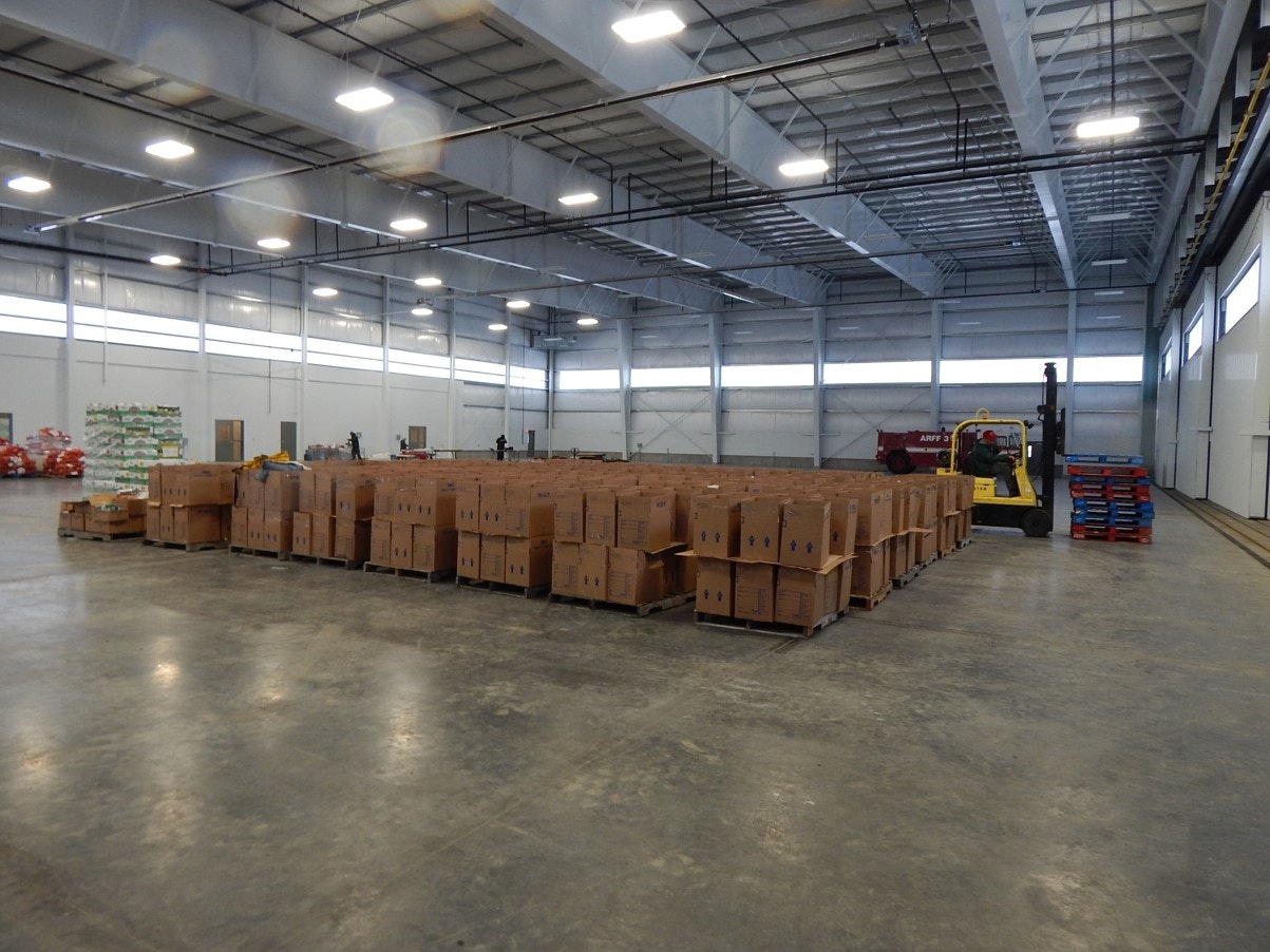 A warehouse with cardboard boxes and a forklift.