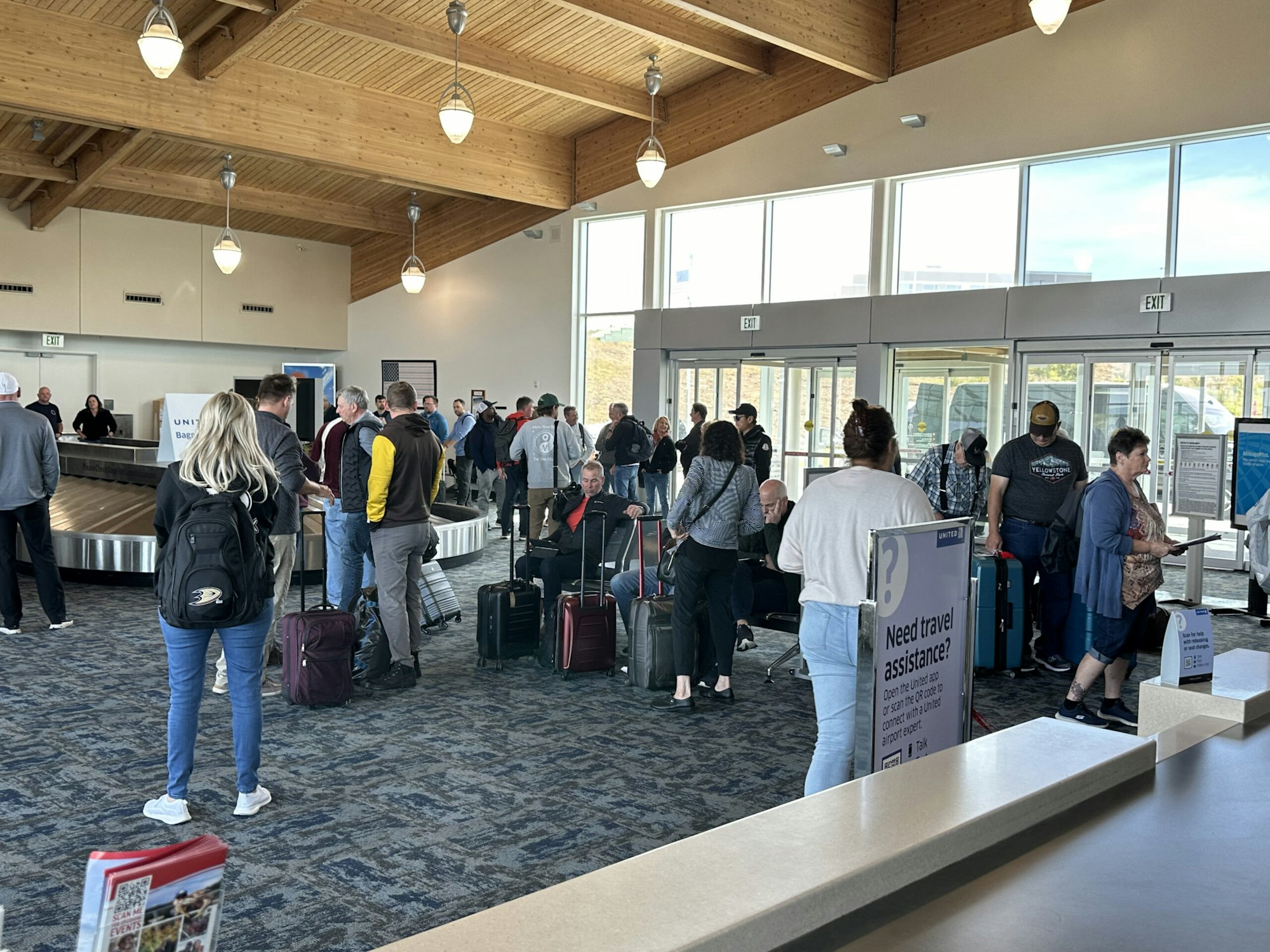 People waiting at an airport baggage claim area.