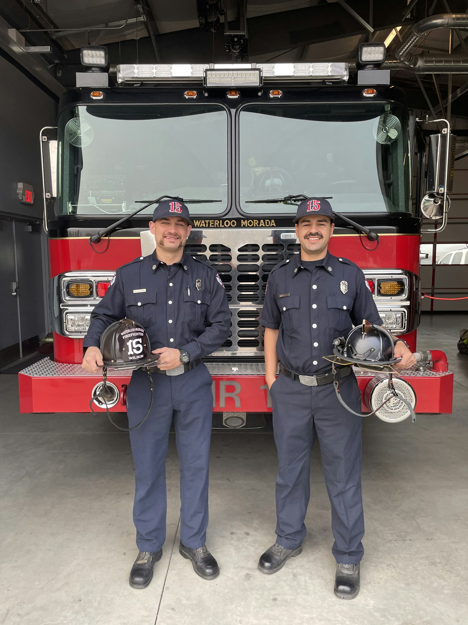 May contain: helmet, clothing, footwear, shoe, adult, male, man, person, hat, wristwatch, accessories, belt, fire truck, transportation, truck, vehicle, and bumper