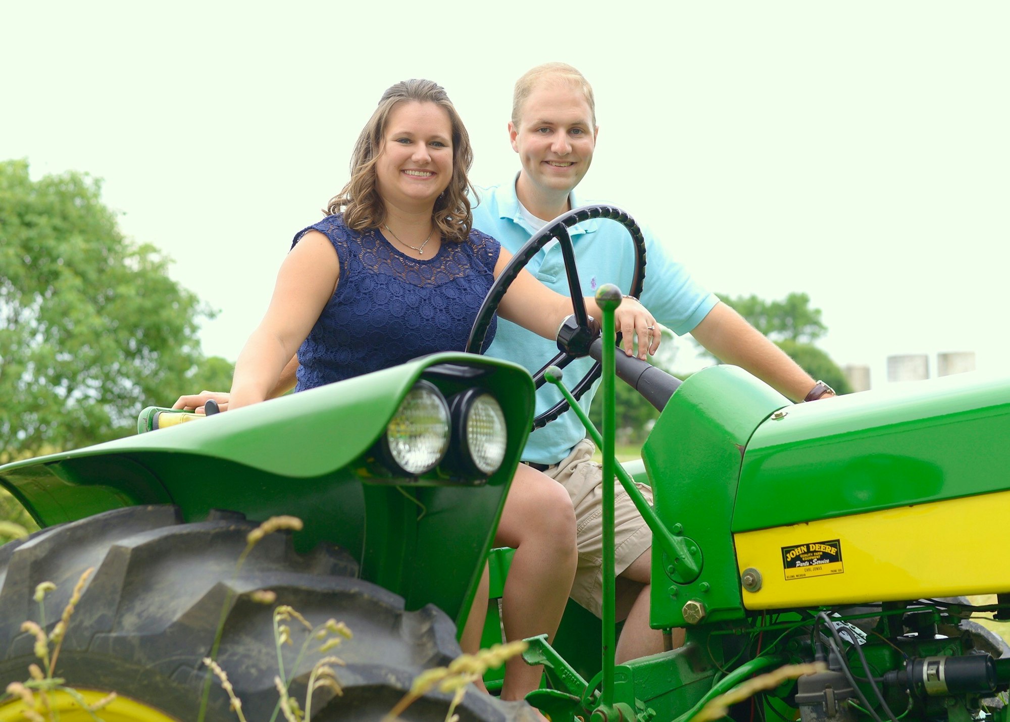 Photograph of Amanda and her husband Chad on a tractor