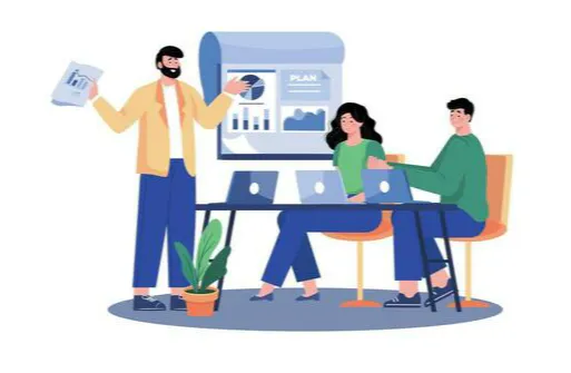 A group meeting with three people discussing a plan, featuring laptops, a presentation chart, and a potted plant.