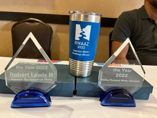 Two awards and a tumbler. Awards: "Manager of the Year 2022" and "System of the Year 2022." RWA Arizona event.