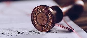 A notary seal stamp lying on a document.
